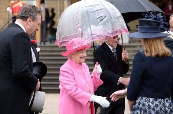 Queen Elizabeth Meets Guests at Buckingham Palace