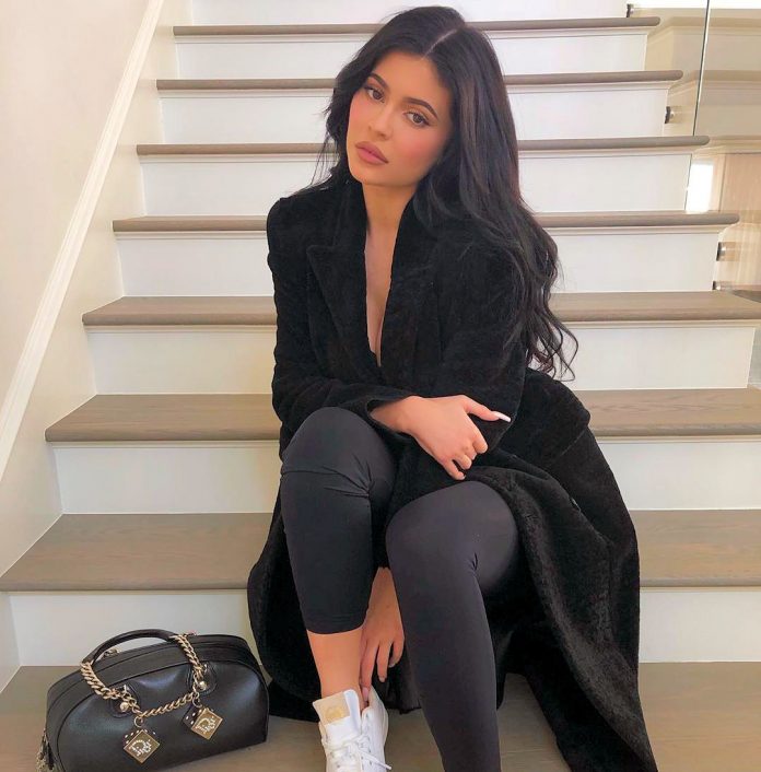 Kylie Jenner sitting on the stairs